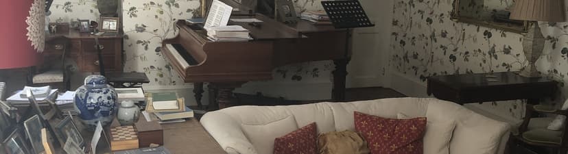 Large victorian music room with grand piano.